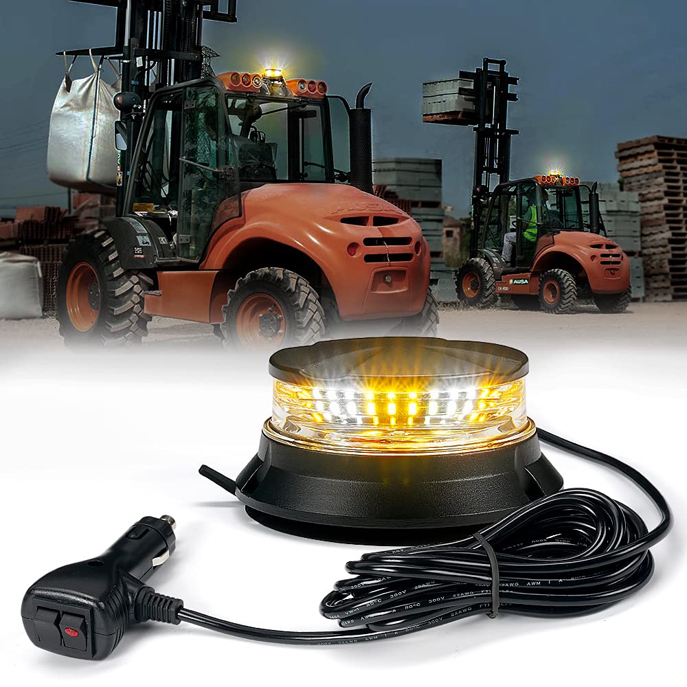 Amber warning light with power cord in front of forklifts on a construction site background